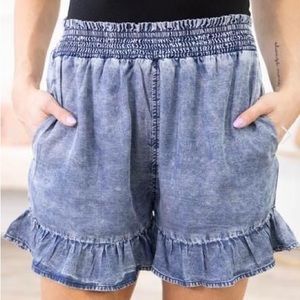 Medium washed bleached smock waist shorts